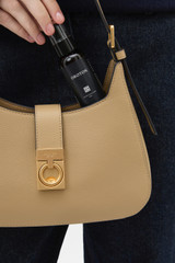 Profile view of model wearing the Oroton Yvonne Baguette in MUSHROOM and Premium pebble leather for Women .
