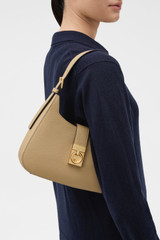 Profile view of model wearing the Oroton Yvonne Baguette in MUSHROOM and Premium pebble leather for Women .