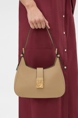 Profile view of model wearing the Oroton Yvonne Baguette in MUSHROOM and Premium pebble leather for Women .