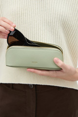 Profile view of model wearing the Oroton Lilly Duet Sunglasses Case in ROSEMARY and Premium pebble leather for Women .