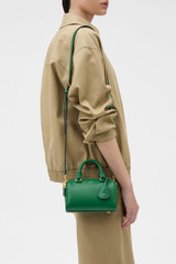 Profile view of model wearing the Oroton Harvey Tiny Barrel in CROCODILE and Premium smooth leather for Women .