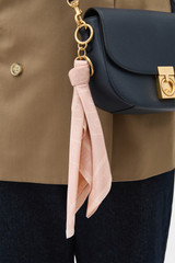 Profile view of model wearing the Oroton Eve Scarf Keyring in BLOSSOM and 100% polyester fabric for Women .