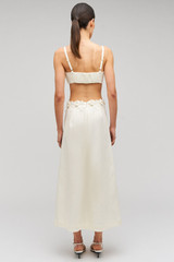 Profile view of model wearing the Oroton Rosebud Lace Skirt in Soft Cream and 100% linen material for Women .