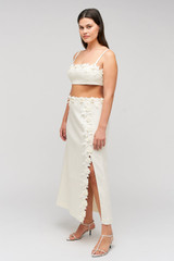 Profile view of model wearing the Oroton Rosebud Lace Skirt in Soft Cream and 100% linen material for Women .