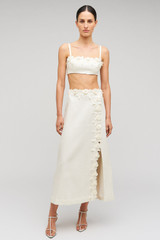Profile view of model wearing the Oroton Rosebud Lace Skirt in Soft Cream and 100% linen material for Women .