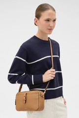Profile view of model wearing the Oroton Dylan Camera Crossbody in Tan and Premium pebble leather for Women .