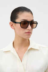 Profile view of model wearing the Oroton Sailor Sunglasses in Black and Acetate material for Women .