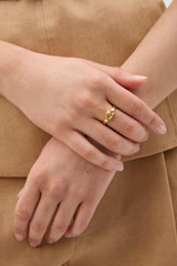 Profile view of model wearing the Oroton Ada Ring in SHINY GOLD and Premium brass material for Women .
