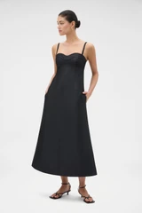 Profile view of model wearing the Oroton Sculptured Bodice Dress in BLACK and 85% polyester and 15% silk blend fabric for Women .