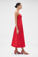 Profile view of model wearing the Oroton Sculptured Bodice Dress in POPPY and 85% polyester and 15% silk blend fabric for Women .