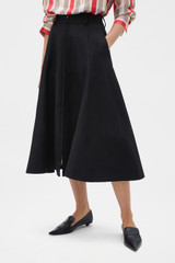 Profile view of model wearing the Oroton Zip Midi Skirt in BLACK and 100% heavyweight linen fabric for Women .