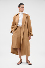 Profile view of model wearing the Oroton Linen Trench in CAMEL and 100% heavyweight linen fabric for Women .