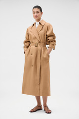 Profile view of model wearing the Oroton Linen Trench in CAMEL and 100% heavyweight linen fabric for Women .