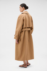 Profile view of model wearing the Oroton Linen Trench in CAMEL and 100% heavyweight linen fabric for Women . IP:5