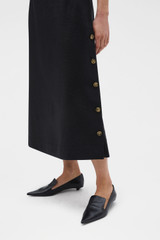 Profile view of model wearing the Oroton Button Detail Dress in BLACK and 100% heavyweight linen fabric for Women .