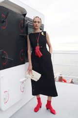 Profile view of model wearing the Oroton Button Detail Dress in BLACK and 100% heavyweight linen fabric for Women .