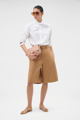 Profile view of model wearing the Oroton Tie Neck Shirt in WHITE and 100% cotton poplin fabric for Women .