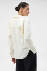 Profile view of model wearing the Oroton Half Placket Tunic in SOFT CREAM and 100% heavyweight linen fabric for Women .