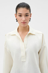 Profile view of model wearing the Oroton Half Placket Tunic in SOFT CREAM and 100% heavyweight linen fabric for Women .
