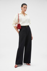 Profile view of model wearing the Oroton Half Placket Tunic in SOFT CREAM and 100% heavyweight linen fabric for Women .