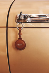 Detail product shot of the Oroton Larsen Air Tag Keychain in SADDLE BROWN and Premium pebble leather for Men .