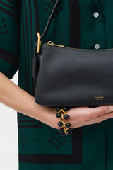 Profile view of model wearing the Oroton Cali Baguette in BLACK and Premium smooth leather for Women .