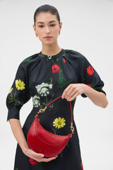 Profile view of model wearing the Oroton Florence Small Shoulder Bag in LAVA and Premium crackle leather for Women . IP:2