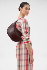 Profile view of model wearing the Oroton Florence Medium Hobo in COPPER and Premium crackle leather for Women .