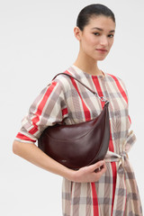 Profile view of model wearing the Oroton Florence Medium Hobo in COPPER and Premium crackle leather for Women .
