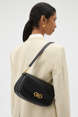 Profile view of model wearing the Oroton Olivia Day Bag in BLACK and Premium crackle leather for Women .