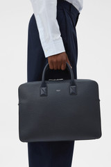 Profile view of model wearing the Oroton Larsen Briefcase in NIGHT SKY and Premium pebble leather for Men .