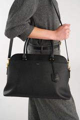 Profile view of model wearing the Oroton Iris Double Zip 14" Tote Bag in Black and Premium pebble leather for Women .