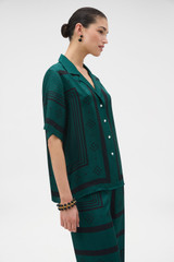 Profile view of model wearing the Oroton SPOT SCARF BELT CAMP SHIRT in HELM GREEN and 100% silk twill fabric for Women .