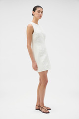 Profile view of model wearing the Oroton Broderie Trim Shift Dress in SOFT CREAM and 100% heavyweight linen fabric for Women .