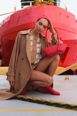 Profile view of model wearing the Oroton Broderie Trim Dress in CAMEL and 100% heavyweight linen fabric for Women .