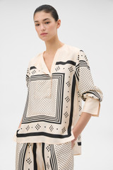 Profile view of model wearing the Oroton Spot Scarf Print Blouse in NOUGAT and 100% silk twill fabric for Women .