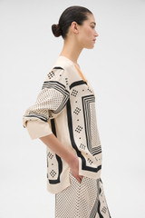Profile view of model wearing the Oroton Spot Scarf Print Blouse in NOUGAT and 100% silk twill fabric for Women .