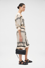 Profile view of model wearing the Oroton Spot Scarf Print Culotte in NOUGAT and 100% silk twill fabric for Women .