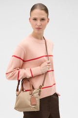 Profile view of model wearing the Oroton Lilly Nylon Small Crossbody Tote in MUSHROOM/COGNAC and Nylon fabric for Women .
