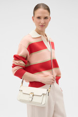 Profile view of model wearing the Oroton Dylan Day Bag in CREAM and Premium pebble leather for Women .