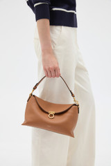 Profile view of model wearing the Oroton Yvonne Bowler Bag in TAN and Premium pebble leather for Women .