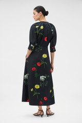 Profile view of model wearing the Oroton Wild Flower Print Dress in BLACK and 100% silk twill fabric for Women .