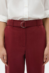 Profile view of model wearing the Oroton Quinn Webbing Belt in ROUGE and 100% cotton material for Women .