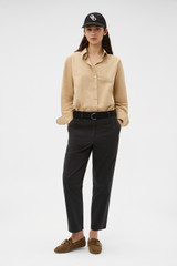 Profile view of model wearing the Oroton Wren Poplin Shirt in CASHEW and 100% cotton fabric for Women .