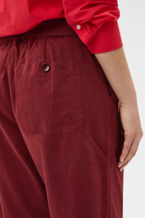 Profile view of model wearing the Oroton Arlo Carpenter Chino in Rouge and 100% cotton fabric for Women .