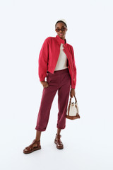 Profile view of model wearing the Oroton Arlo Carpenter Chino in Rouge and 100% cotton fabric for Women .