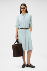 Profile view of model wearing the Oroton Chambray Skirt in Chambray and 100% cotton fabric for Women .