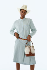 Profile view of model wearing the Oroton Chambray Skirt in Chambray and 100% cotton fabric for Women .