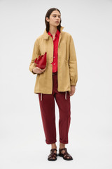 Profile view of model wearing the Oroton Arlo Washed Parka in Cashew and 100% cotton fabric for Women . IP:6