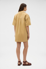 Profile view of model wearing the Oroton Drill Popover Dress in Cashew and 100% cotton fabric for Women .
